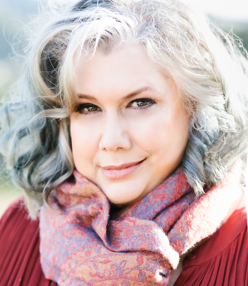 Close up of Paula Morris. She is wearing a scarf around her neck. Photo credit: Colleen Maria Lenihan.